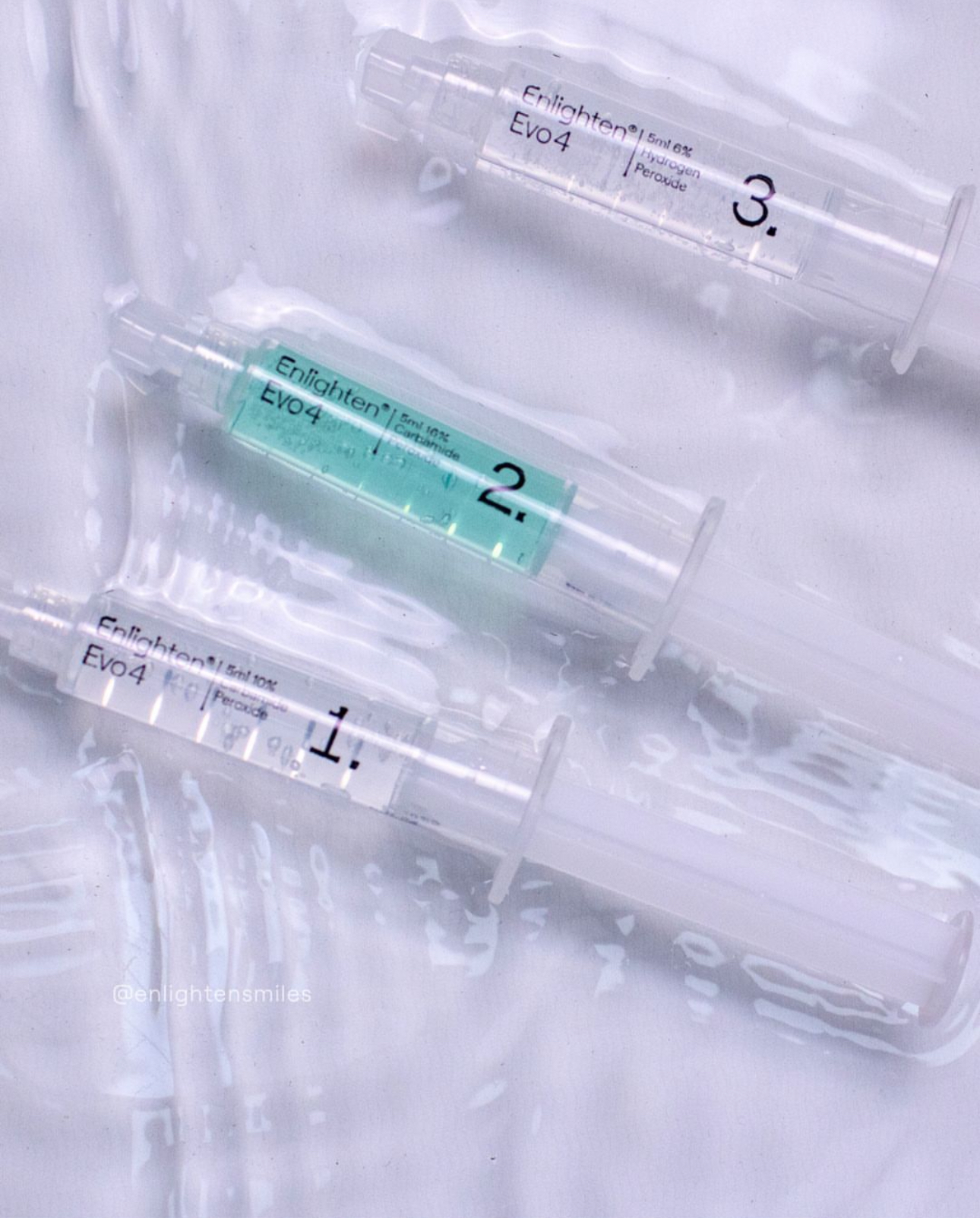 Close up of Enlighten teeth whitening syringes. 