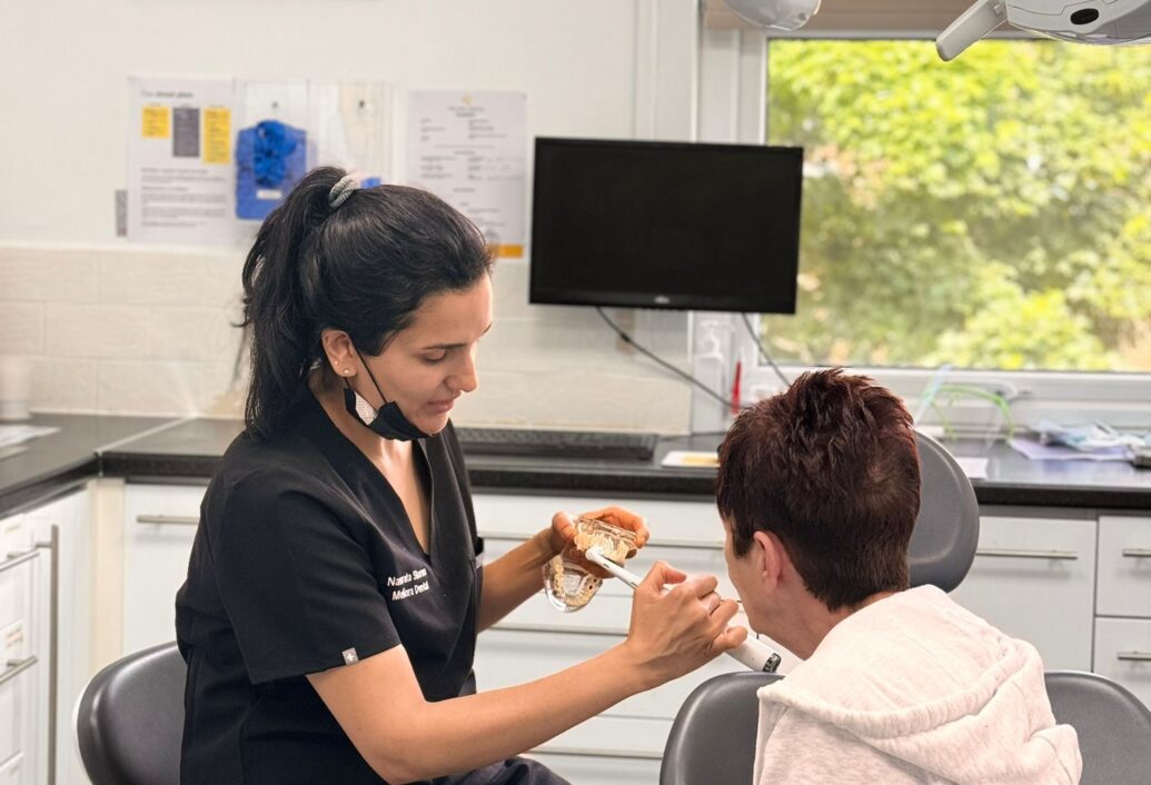 Dr Namrata is speaking to a female patient in the dentist's chair.